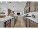 Contemporary kitchen with stainless steel appliances, a large sink, and seamless transition into the living room at 705 Carlon Hills Ave, Las Vegas, NV 89138