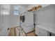 Functional laundry room with washer and dryer, storage cabinets, and shelving for supplies at 705 Carlon Hills Ave, Las Vegas, NV 89138