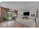 Bright living room with a sliding glass door to the backyard, a cozy fireplace, and stylish furnishings at 705 Carlon Hills Ave, Las Vegas, NV 89138