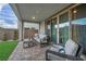 Inviting patio with stylish furniture, brick pavers, and easy access to the indoors through sliding glass doors at 705 Carlon Hills Ave, Las Vegas, NV 89138