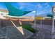 Spacious backyard with paver patio, artificial turf, outdoor kitchen and shade sails at 7219 Quiet Spring St, North Las Vegas, NV 89084