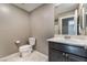 Functional bathroom with a vanity sink, toilet, and neutral tile flooring at 7219 Quiet Spring St, North Las Vegas, NV 89084