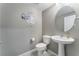 Cozy half bathroom featuring a round mirror and Mickey Mouse wall art at 7219 Quiet Spring St, North Las Vegas, NV 89084