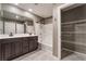 Bathroom with double vanity, a combined tub and shower, and built-in storage at 7219 Quiet Spring St, North Las Vegas, NV 89084