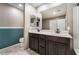 Bathroom featuring a double vanity, modern fixtures, and stylish blue wainscoting at 7219 Quiet Spring St, North Las Vegas, NV 89084