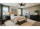 This bedroom has a ceiling fan, two windows, a bed, and matching nightstands at 7219 Quiet Spring St, North Las Vegas, NV 89084
