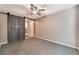 Large bedroom with a ceiling fan and a sliding barn door leading to the bathroom at 7219 Quiet Spring St, North Las Vegas, NV 89084