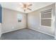 Well-lit bedroom with gray carpet, large windows, and neutral walls, ideal for relaxation at 7219 Quiet Spring St, North Las Vegas, NV 89084