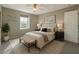 Stylishly furnished bedroom with a comfortable bed, elegant lamps, and a cozy rug at 7219 Quiet Spring St, North Las Vegas, NV 89084