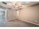 Neutral bedroom with gray walls, ceiling fan, and gray carpet, offering a tranquil retreat at 7219 Quiet Spring St, North Las Vegas, NV 89084