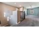 Spacious bonus room with neutral walls, carpet, and a staircase with black metal railing at 7219 Quiet Spring St, North Las Vegas, NV 89084