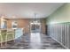 Eat in kitchen with bar seating, modern light fixture, and access to back yard at 7219 Quiet Spring St, North Las Vegas, NV 89084