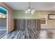 Open dining room area with stylish wood paneling, modern lighting, and access to the outdoor living space at 7219 Quiet Spring St, North Las Vegas, NV 89084