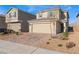 Inviting two-story home with a two-car garage and charming desert landscaping at 7219 Quiet Spring St, North Las Vegas, NV 89084