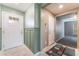 Bright foyer with tiled floors, decorative wall paneling, and views into adjacent living spaces at 7219 Quiet Spring St, North Las Vegas, NV 89084
