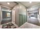 Hallway with tile and views of living spaces and decorative seafoam wainscoting at 7219 Quiet Spring St, North Las Vegas, NV 89084