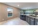 Bright kitchen area featuring tile flooring, a dishwasher, and a window with views of the outdoors at 7219 Quiet Spring St, North Las Vegas, NV 89084