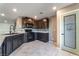 Well-equipped kitchen with granite countertops, dark cabinets, and modern appliances at 7219 Quiet Spring St, North Las Vegas, NV 89084