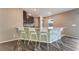 Kitchen island with a granite countertop, seating for four, and modern fixtures at 7219 Quiet Spring St, North Las Vegas, NV 89084