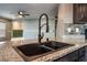 Close-up of a modern kitchen sink with granite countertops and updated fixtures at 7219 Quiet Spring St, North Las Vegas, NV 89084