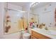 Bright bathroom featuring tub/shower with glass door, vanity, and lighting fixture at 7400 W Flamingo Rd # 1087, Las Vegas, NV 89147