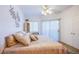 Comfortable bedroom with plush bedding, natural light, and sliding door access at 7400 W Flamingo Rd # 1087, Las Vegas, NV 89147