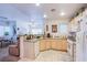 Bright kitchen with light wood cabinetry, white appliances, and a breakfast bar open to the dining area at 7400 W Flamingo Rd # 1087, Las Vegas, NV 89147