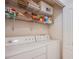 Convenient laundry area with stacked washer and dryer and wire shelving at 7400 W Flamingo Rd # 1087, Las Vegas, NV 89147