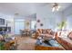 Spacious living room with neutral colored walls, ceiling fans, two couches and dining area at 7400 W Flamingo Rd # 1087, Las Vegas, NV 89147