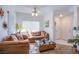 Neutral-toned living room featuring a comfortable sofa, ceiling fan, and window bringing in natural light at 7400 W Flamingo Rd # 1087, Las Vegas, NV 89147