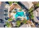 An aerial view of the community pool surrounded by trees, lawn chairs, and covered cabanas at 7400 W Flamingo Rd # 1087, Las Vegas, NV 89147
