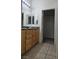 Bathroom with double sinks, granite countertops and tile flooring at 7904 Limbwood Ct, Las Vegas, NV 89131