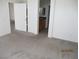 Bright bedroom featuring neutral carpet and an open view to the ensuite at 7904 Limbwood Ct, Las Vegas, NV 89131