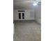 Spacious living area with neutral carpets, large double doors and natural light at 7904 Limbwood Ct, Las Vegas, NV 89131