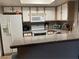 Efficient kitchen featuring white appliances and a breakfast bar for casual dining at 8600 W Charleston Blvd # 1075, Las Vegas, NV 89117