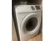 Close-up view of a Samsung front-load washing machine in a small laundry space at 8600 W Charleston Blvd # 1075, Las Vegas, NV 89117