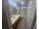 Well-lit bathroom features single sink vanity and a tub with shower at 901 E Jaybird St, Pahrump, NV 89048
