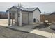 Exterior shot of the backyard dog kennel, with metal mesh gates, surrounded by desert landscaping at 901 E Jaybird St, Pahrump, NV 89048