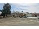 Single-story home featuring a front yard with desert landscaping and a two-car garage at 901 E Jaybird St, Pahrump, NV 89048