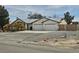 Wide view of property showcasing a multi-car garage, desert landscaping, and ample parking at 901 E Jaybird St, Pahrump, NV 89048