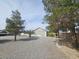 View of the front yard featuring desert landscaping, trees and a glimpse of the home at 901 E Jaybird St, Pahrump, NV 89048