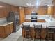Spacious kitchen with stainless steel appliances, light countertops, and wooden cabinets at 901 E Jaybird St, Pahrump, NV 89048