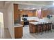 Bright eat-in kitchen with wood cabinets, island, stainless appliances, and tile flooring at 901 E Jaybird St, Pahrump, NV 89048