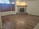 Spacious living room featuring wood floors and a stone fireplace with stone hearth at 901 E Jaybird St, Pahrump, NV 89048