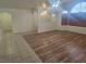 Open-concept living room with wood flooring and large windows for natural light at 901 E Jaybird St, Pahrump, NV 89048