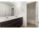 Modern bathroom featuring a double vanity, white countertops, and a shower-tub combination in a well-lit space at 9268 Wildfire Gorge St, Las Vegas, NV 89139