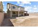 Rear view of home with patio, balcony, stucco, and concrete block wall at 9268 Wildfire Gorge St, Las Vegas, NV 89139