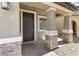 Inviting entryway with stone-accented columns and a modern, dark-stained front door at 9268 Wildfire Gorge St, Las Vegas, NV 89139