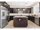 Modern kitchen with stainless steel appliances, island and sleek dark cabinets at 9268 Wildfire Gorge St, Las Vegas, NV 89139