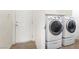 Convenient laundry room with front-load washer and dryer units, and a utility sink at 9268 Wildfire Gorge St, Las Vegas, NV 89139